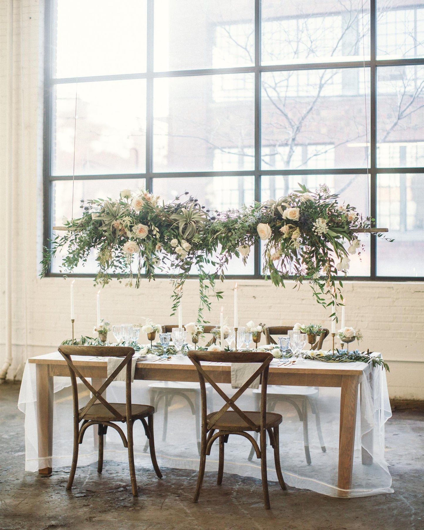 Lush Smilax greenery styled as wedding garland on reception table