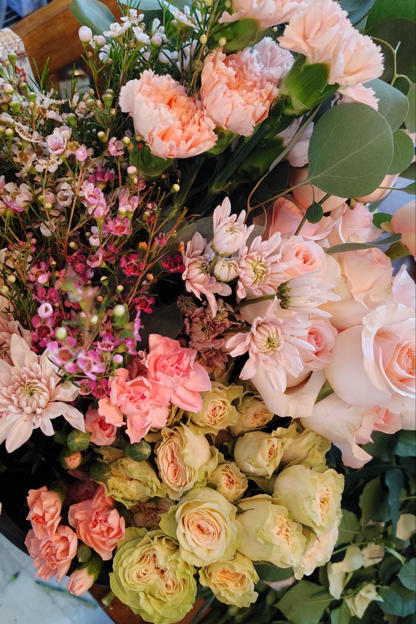 Bouquet of flowers with a mix of pink, green, and white colors.