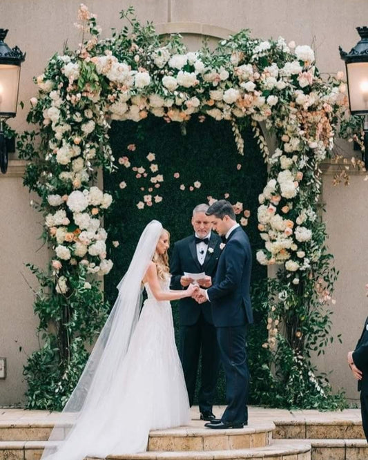 Fresh Smilax vine draping on a wedding arch with natural greenery